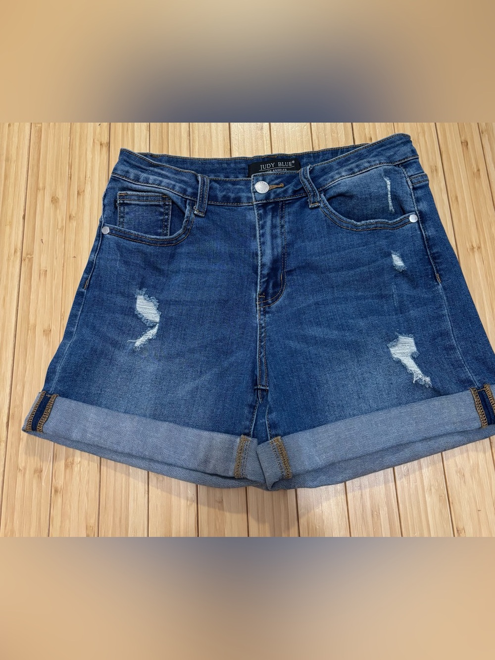 Judy Blue distressed cuffed denim shorts in a medium blue wash.  Size 28.